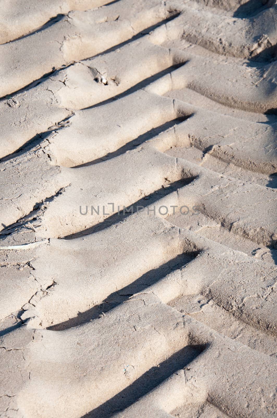 Vertical car track in sand. Mediterranean beach, Spain.
