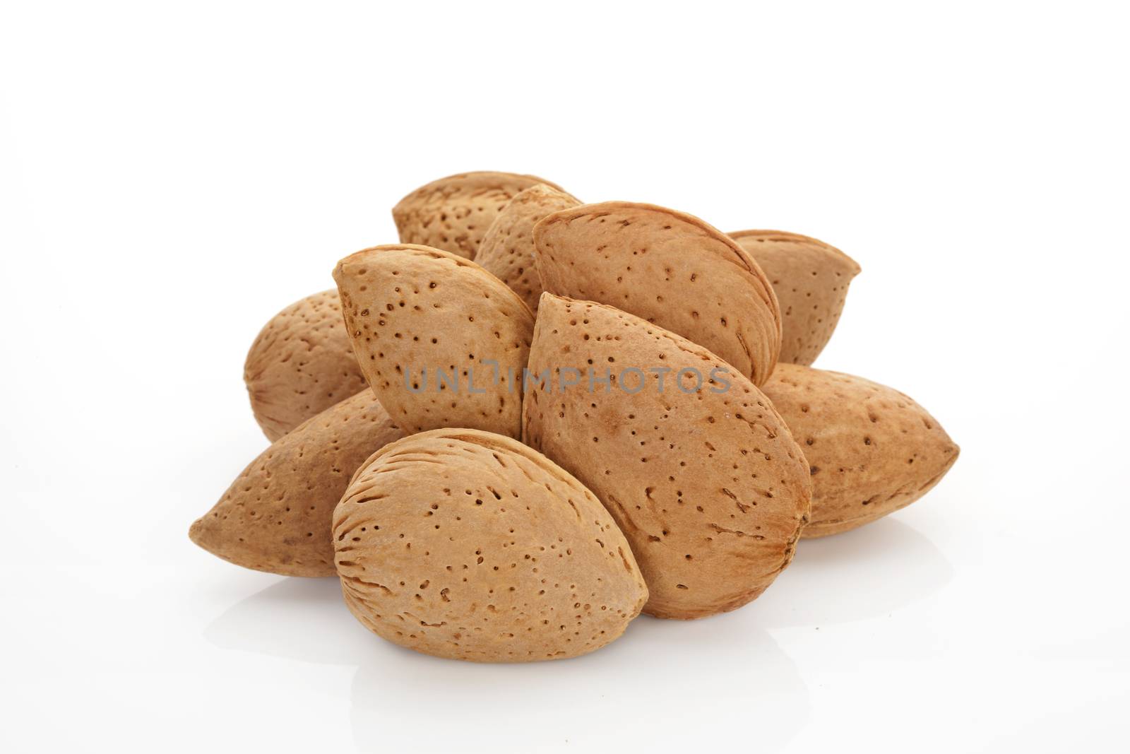 Almond nuts heap isolated on white background. Culinary nuts concept.