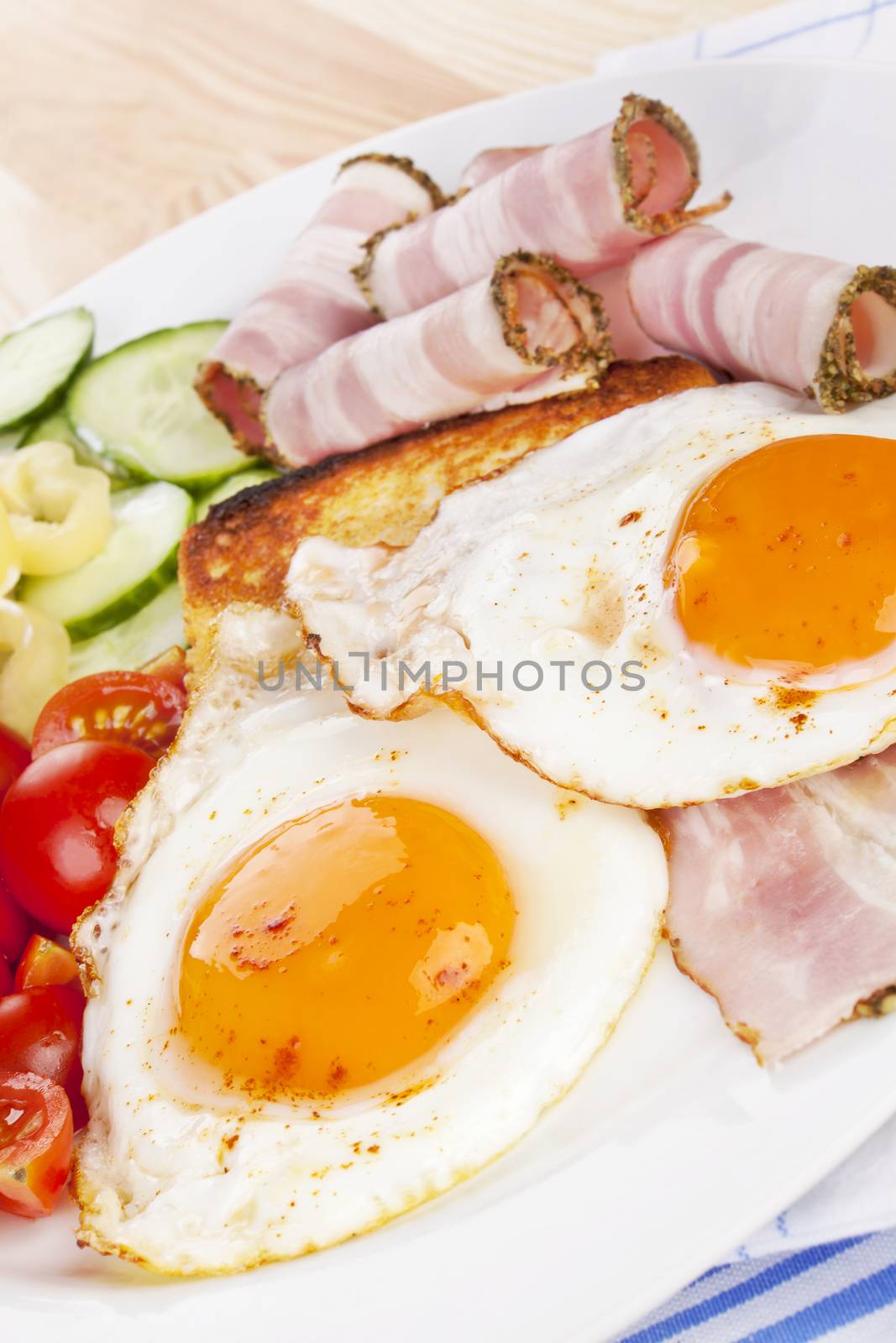 Traditional western breakfast. Fried eggs, ham, toast and fresh vegetable. Tomatoes, cucumber and capsicum. Good morning concept.