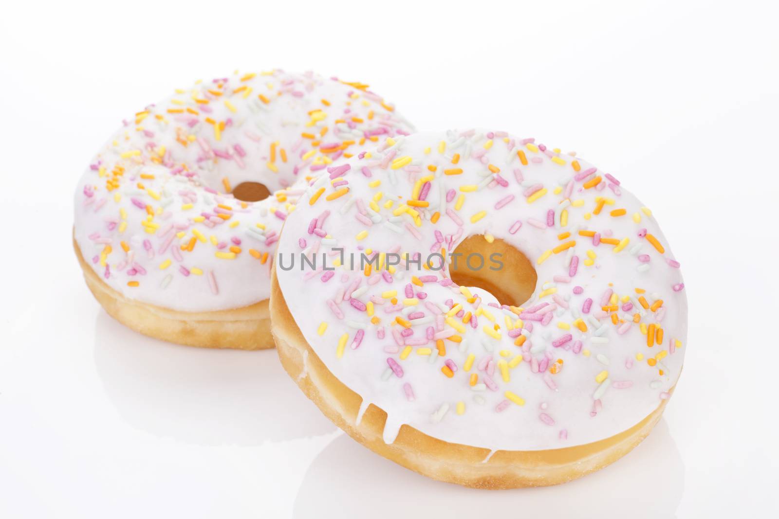 Two luxurious donuts isolated on white background. Culinary sweet desert concept.