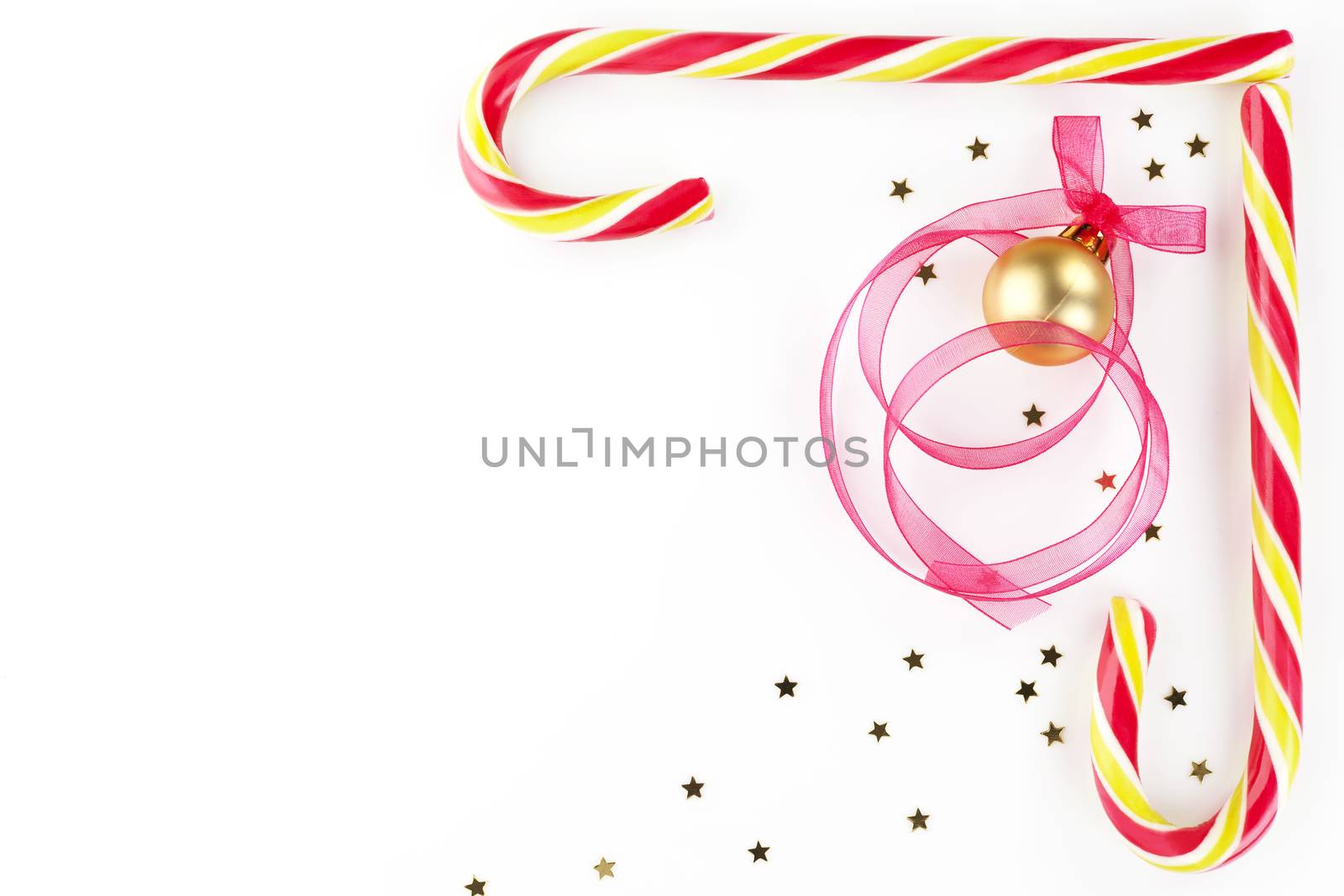 Christmas background with copy space made of candy cane, golden stars, christmas ball and ribbon. Beautiful xmas copy space.