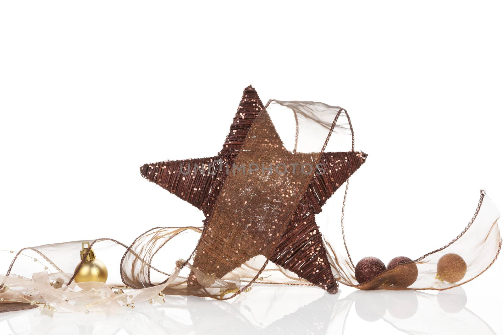 Brown natural star christmas decoration with brown ribbon and golden christmas balls isolated on white background. Modern christmas still life.