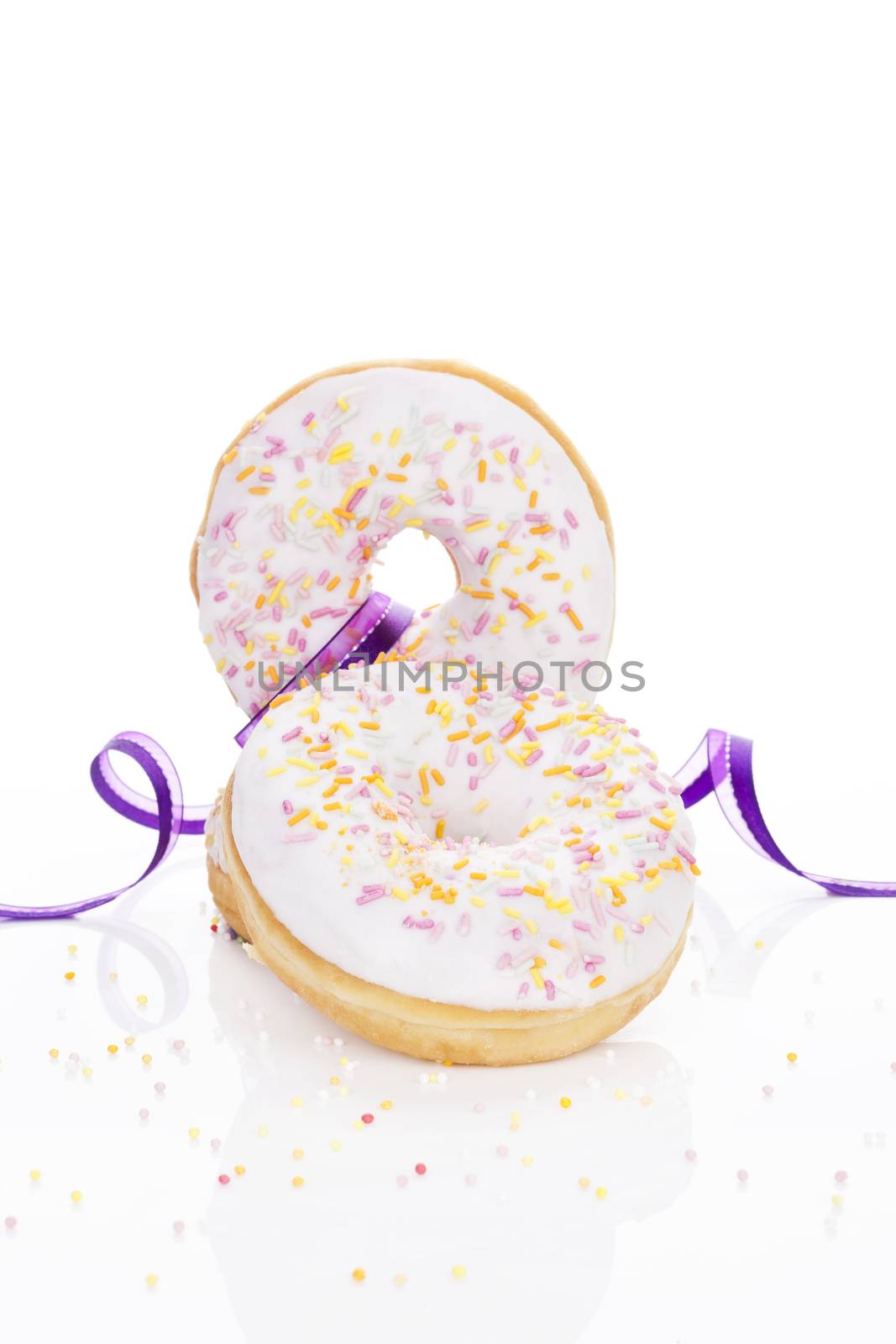 Delicious colorful donuts isolated on white background decorated with garnish. Luxurious sweet desert concept. Good morning.