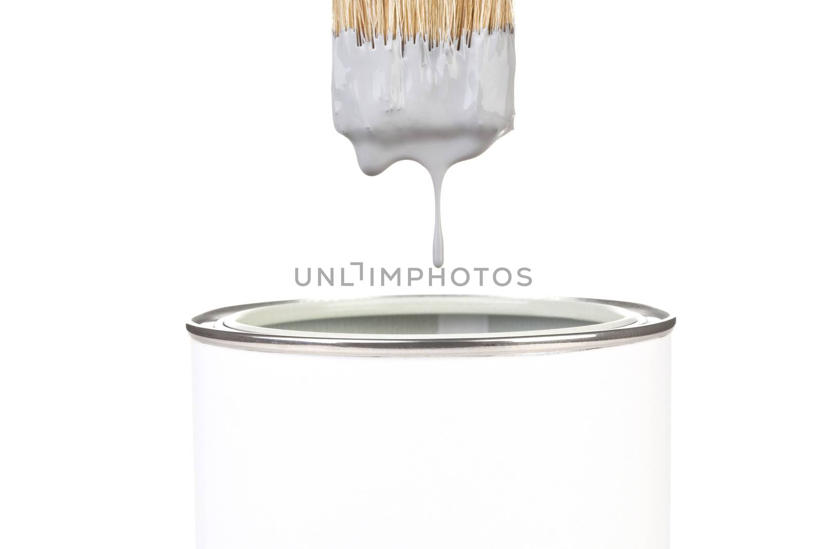 Grey paint dropping from brush into can isolated on white background. DIY creativity concept.
