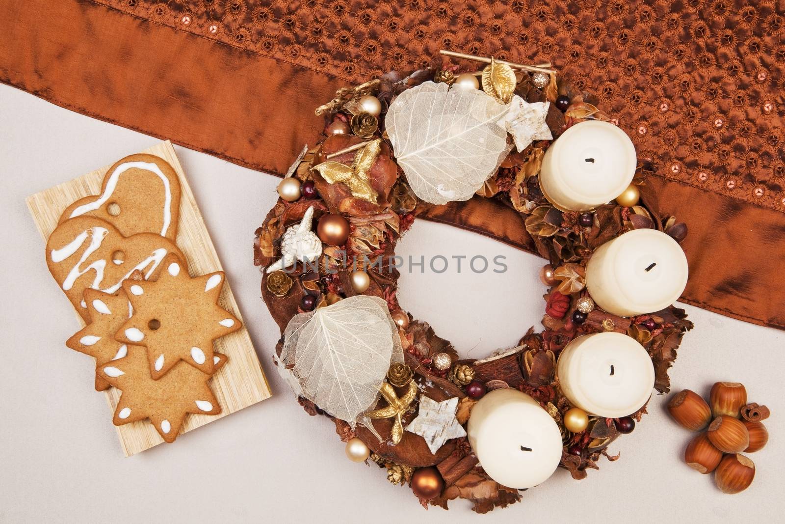 Traditional christmas still life with xmas crown, gingerbread cookies and nuts. Brown traditional natural concept.