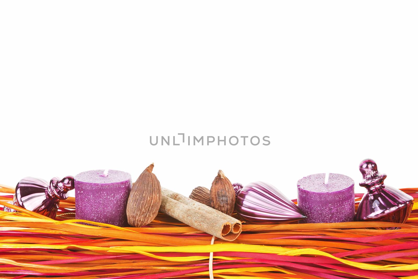 Colorful christmas still life with decor, cinnamon, nutmeg, candles and copy space. Temporary christmas concept.