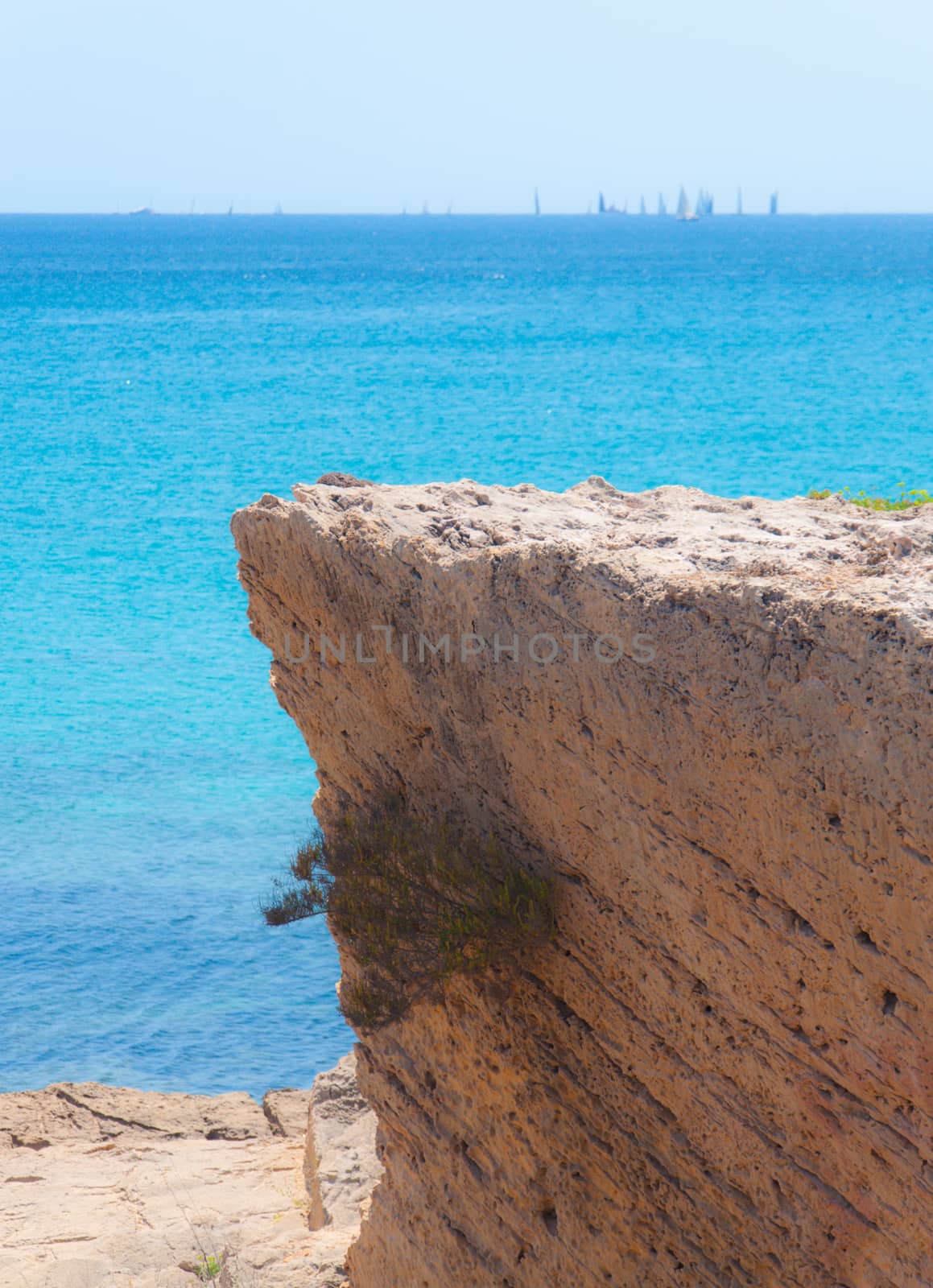 Azure water and yellow limestone cliff in Palma bay, Majorca, Balearic islands, Spain.