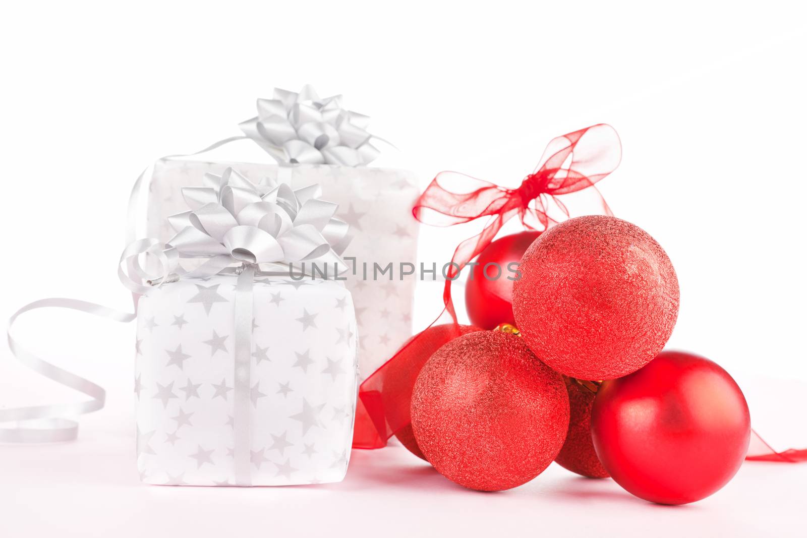 Luxurious christmas background. Red balls and beautifully wrapped presents.