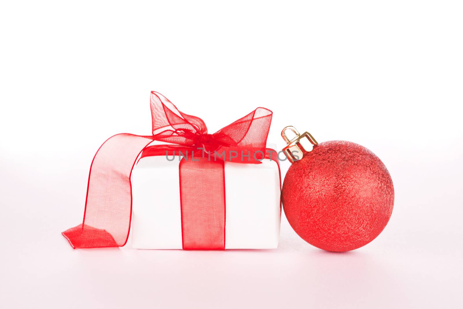 Gift with ribbon and christmas ball isolated. by eskymaks