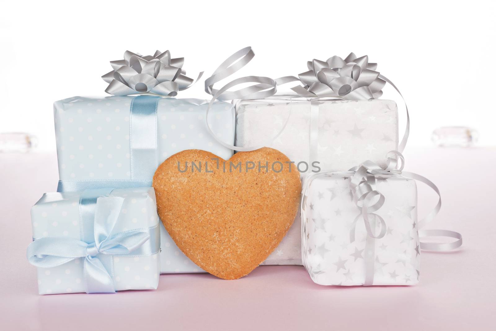 Big and small christmas presents with heart shaped gingerbread for your text. Festive xmas concept.