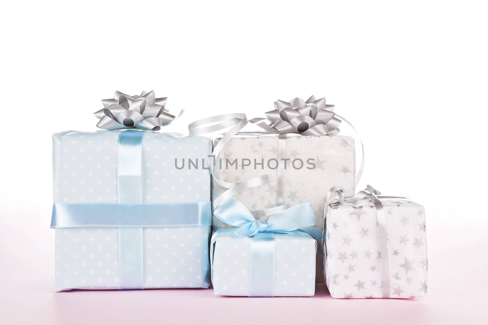 Beautiful gift box set against white and pink gradient background. It is all about giving concept.
