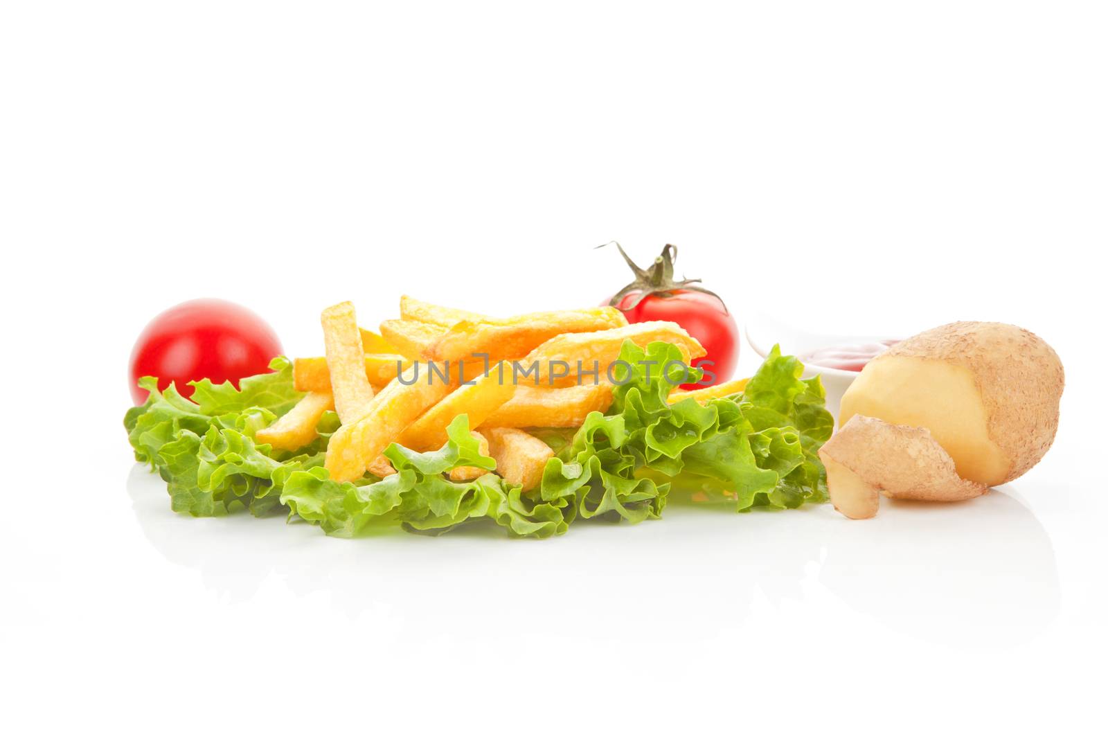 French fries with fresh salad, tomatoes, potatoes and ketchup. Culinary vegetarian eating.