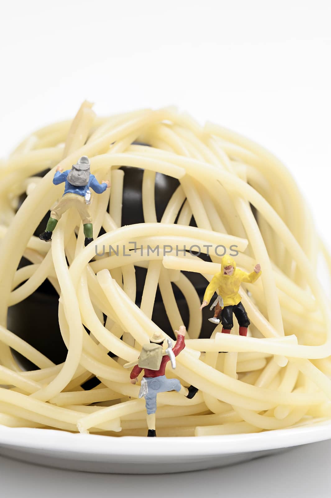Miniature worker work with spaghetti