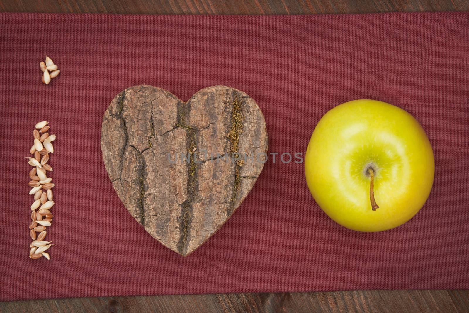 I love apple made of grain, wooden heart and green fresh apple. Healthy eating background.