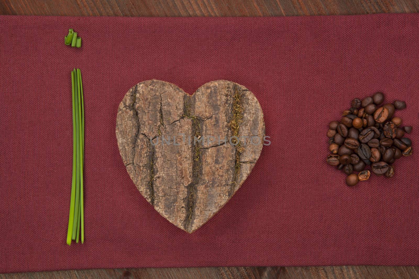 I love coffee made out of chive, wooden heart and coffee beans on burgundy cloth.