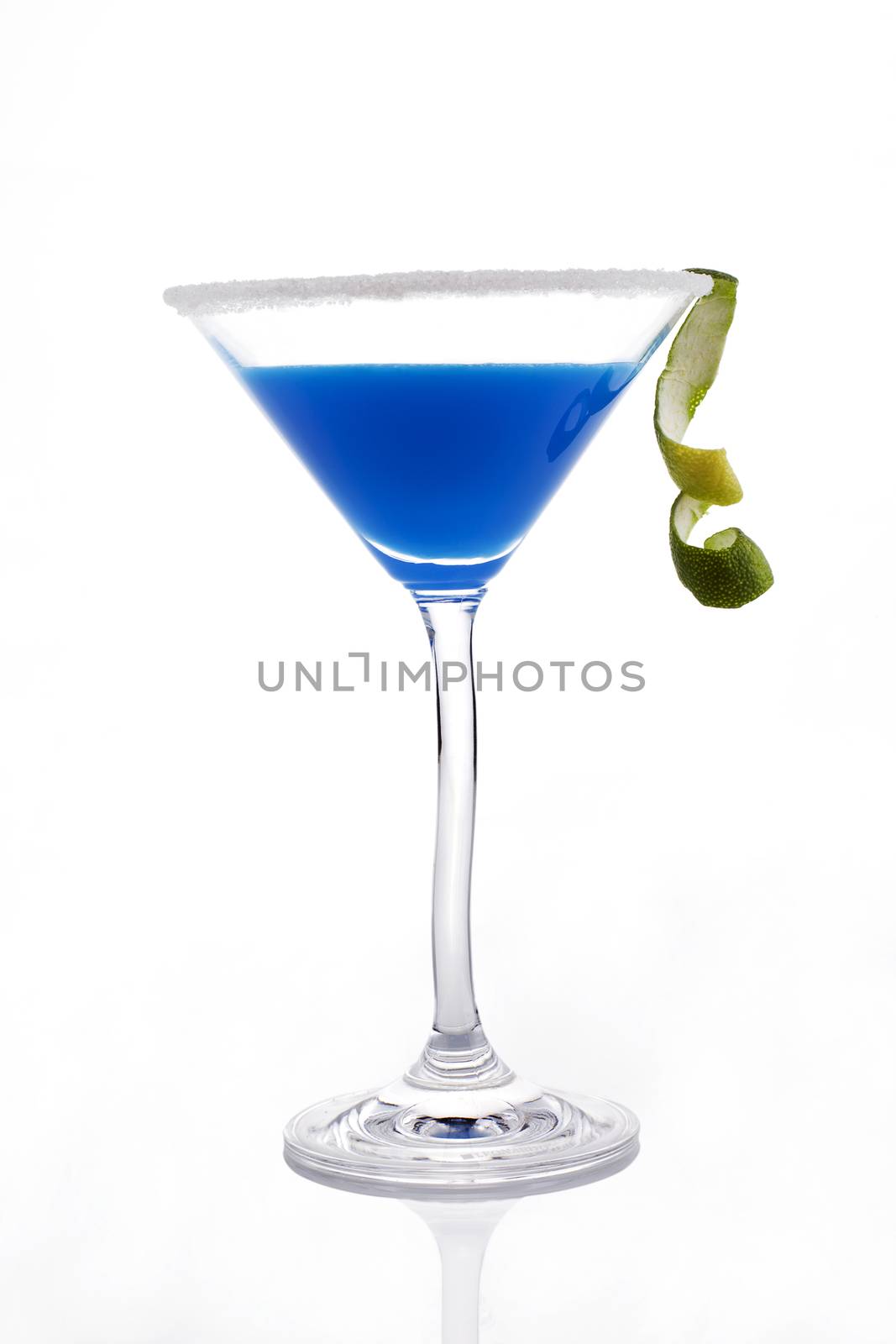 Delicious blue creamy cocktail in cocktail glass isolated on white background. Decorated with lime garnish.