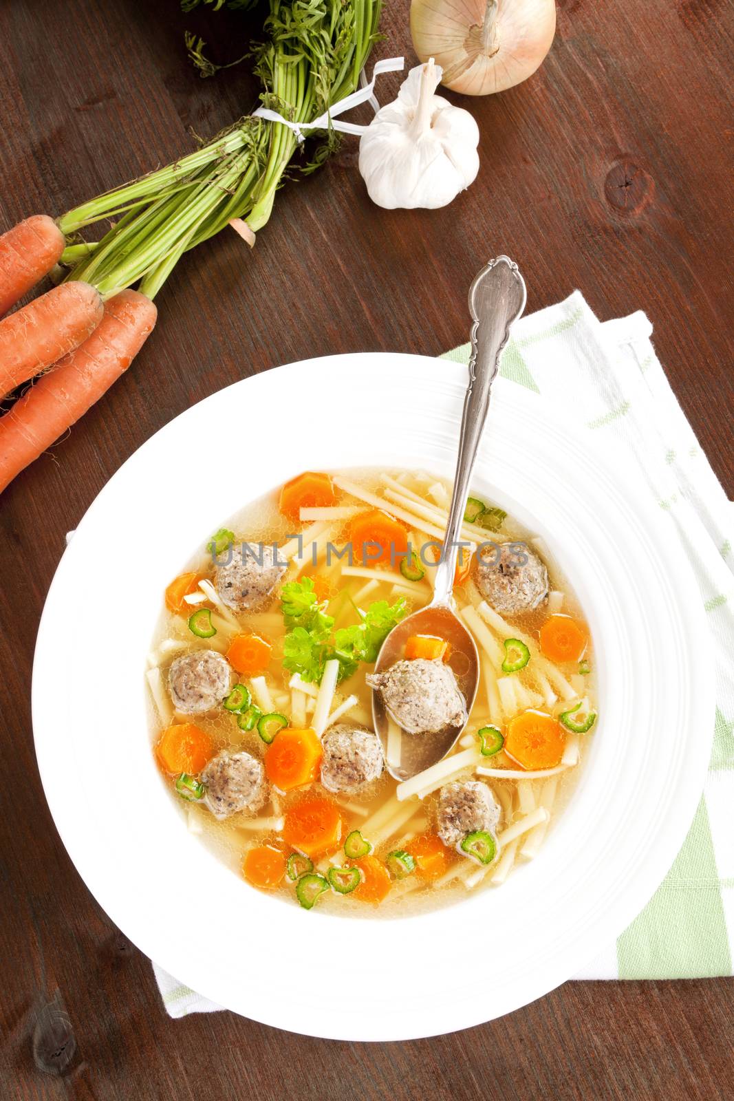 Delicious seasonal homemade vegetable soup with fresh vegetable in background. Healthy eating.
