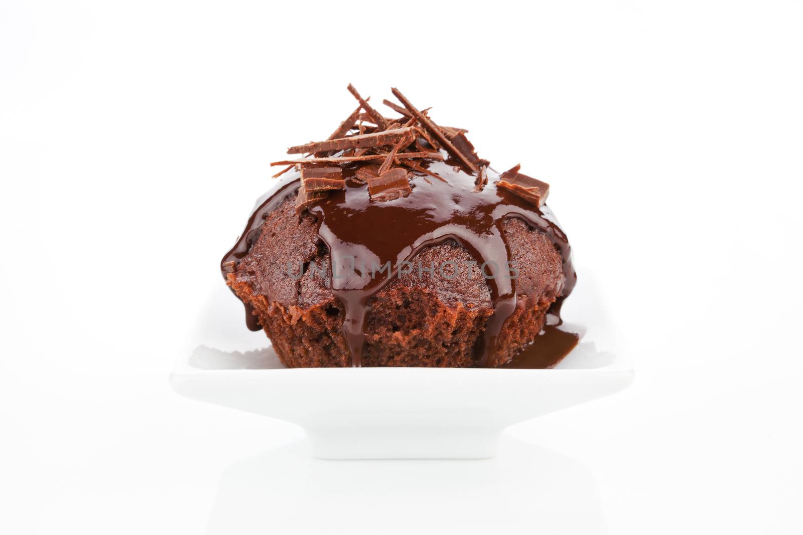 Delicious chocolate muffin with chocolate garnish isolated on white background.