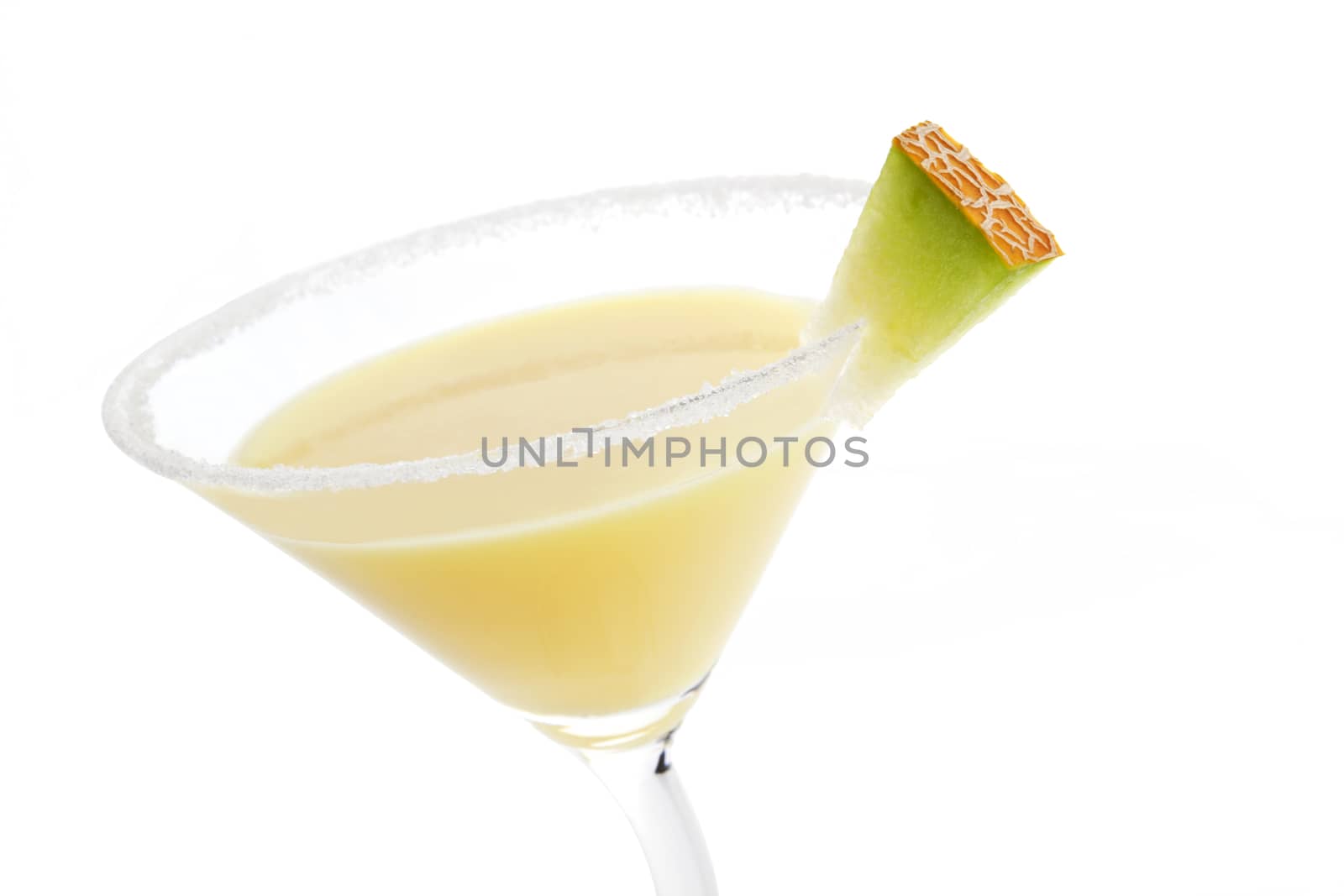 Delicious yellow fruit creamy cocktail detail isolated on white background. Decorated with lime garnish.