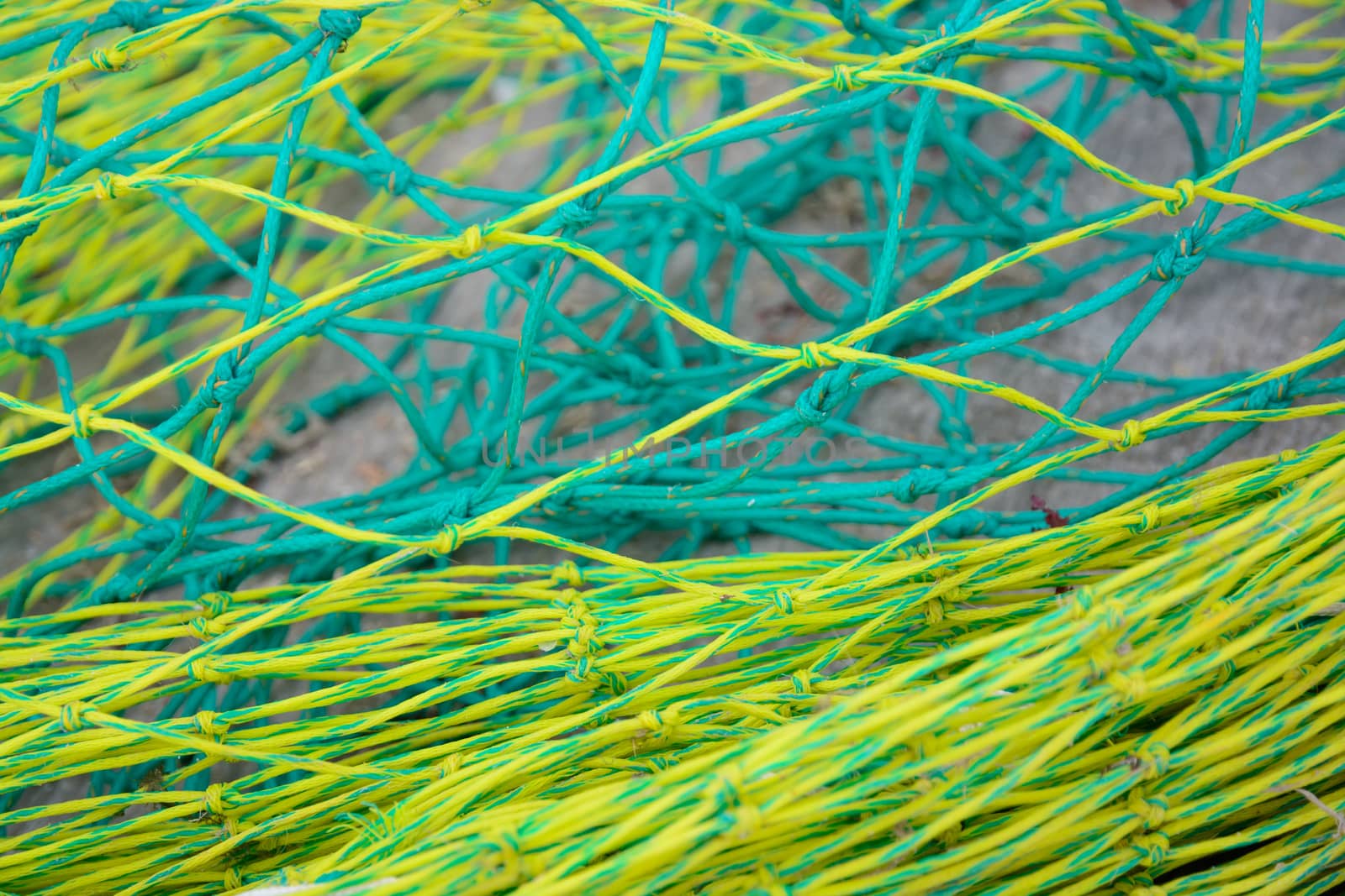 Yellow and green nylon fishing nets close up.