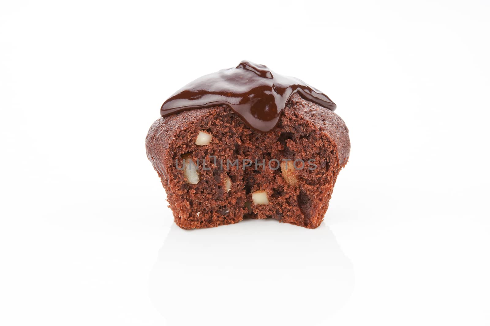 Luxurious homemade chocolate muffin with chocolate garnish isolated on white background.