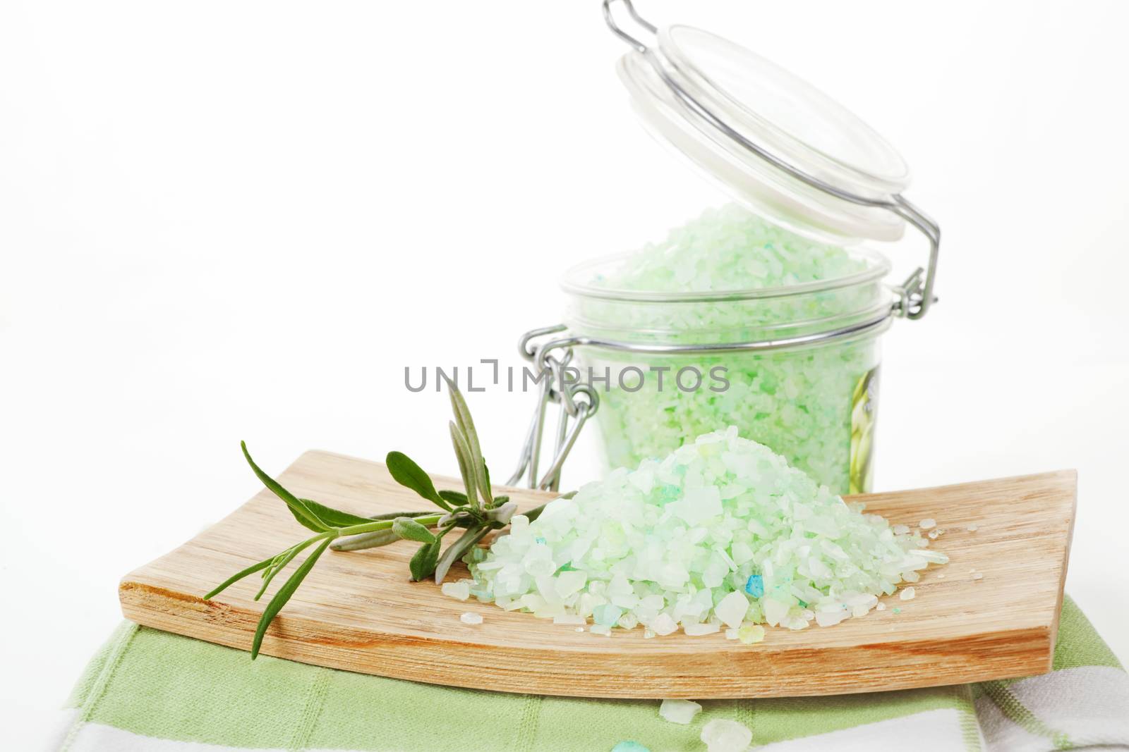 Bath salt on wooden tray and glass container with fresh lavender isolated on white. Beauty background.