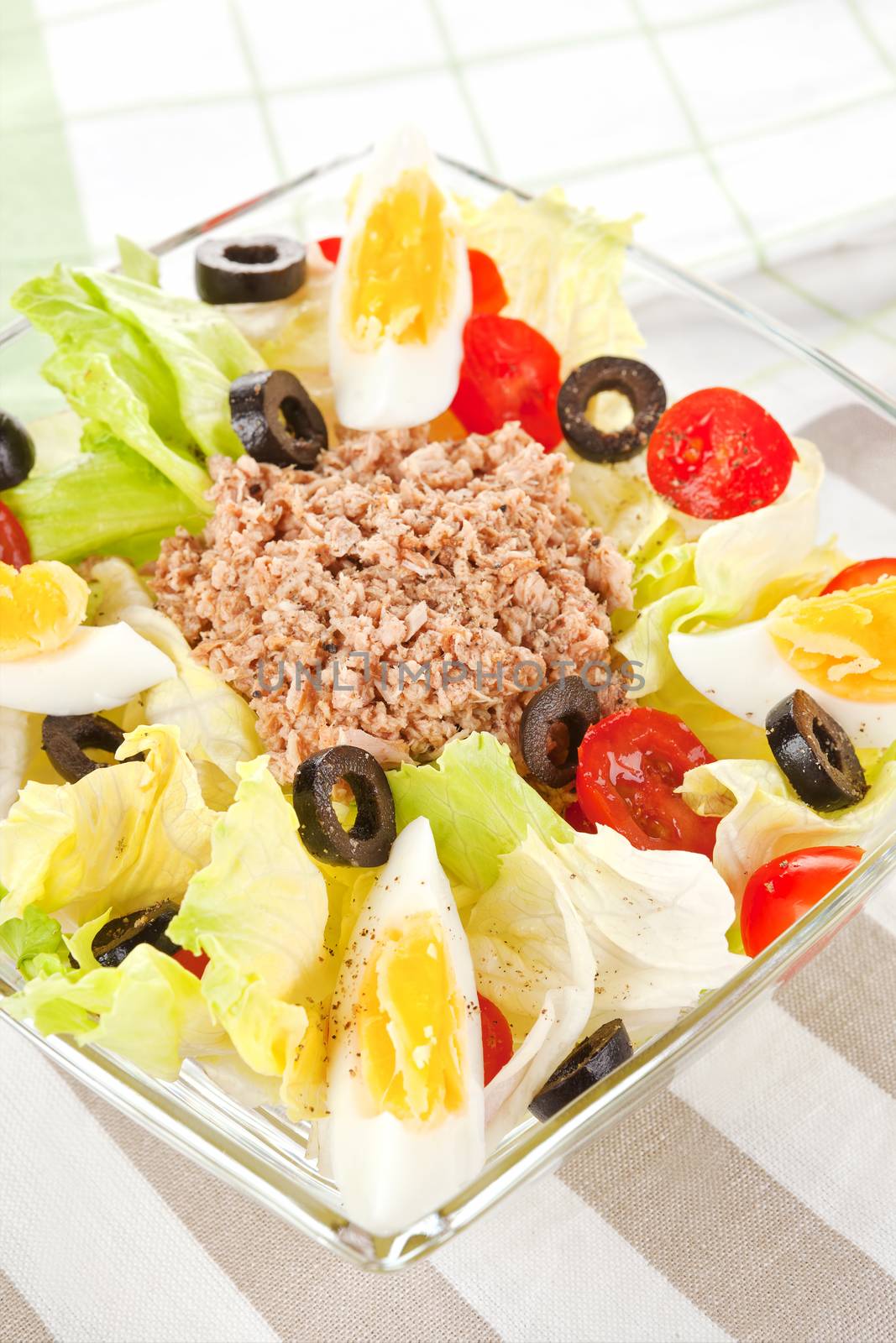 Culinary tuna salad in glass bowl. Light summer salad.