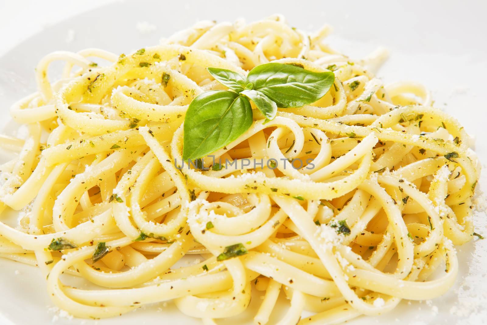 Delicoious spaghetti detail with parmesan cheese and fresh herbs.