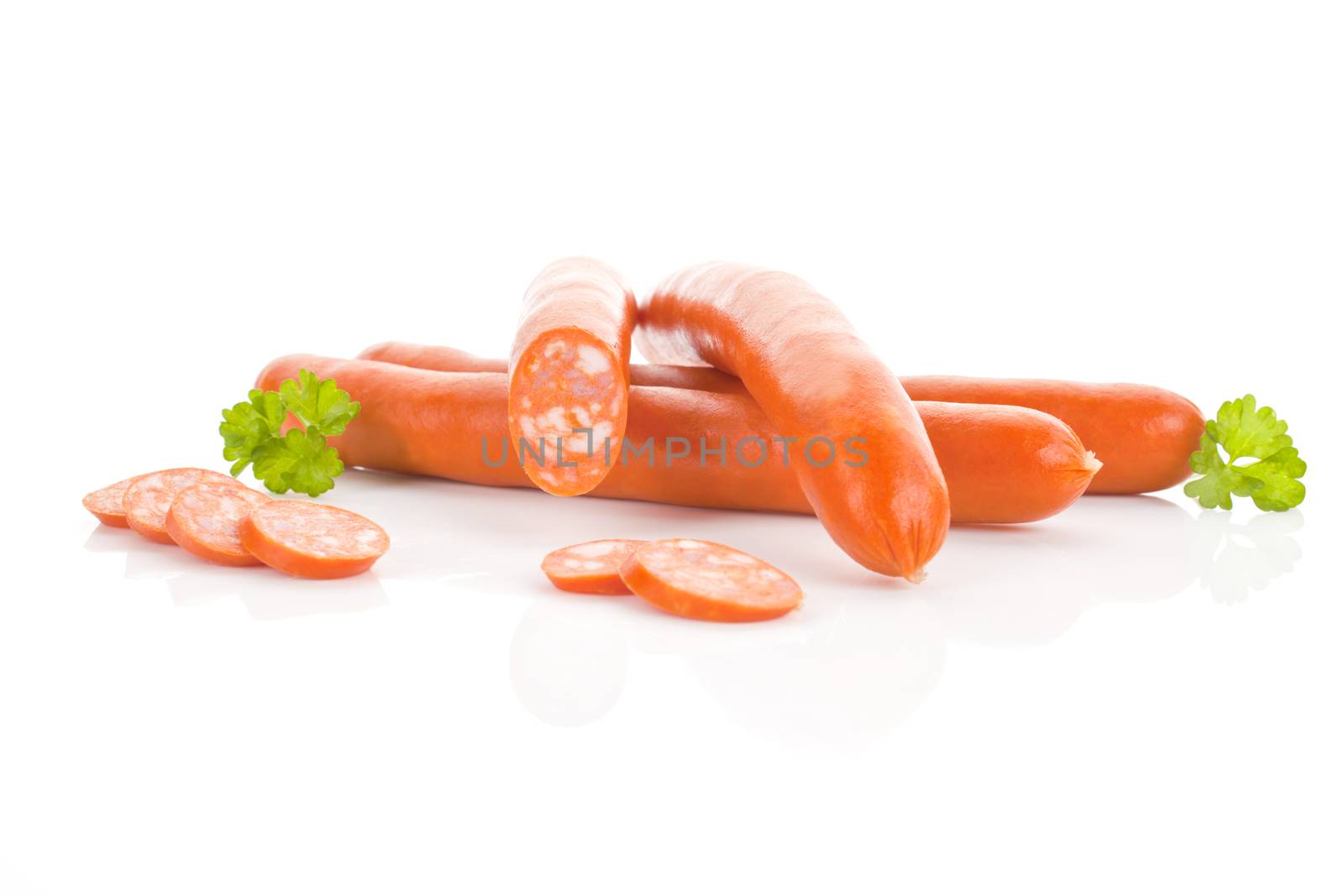 Several sausages isolated on white background. Unhealthy eating.