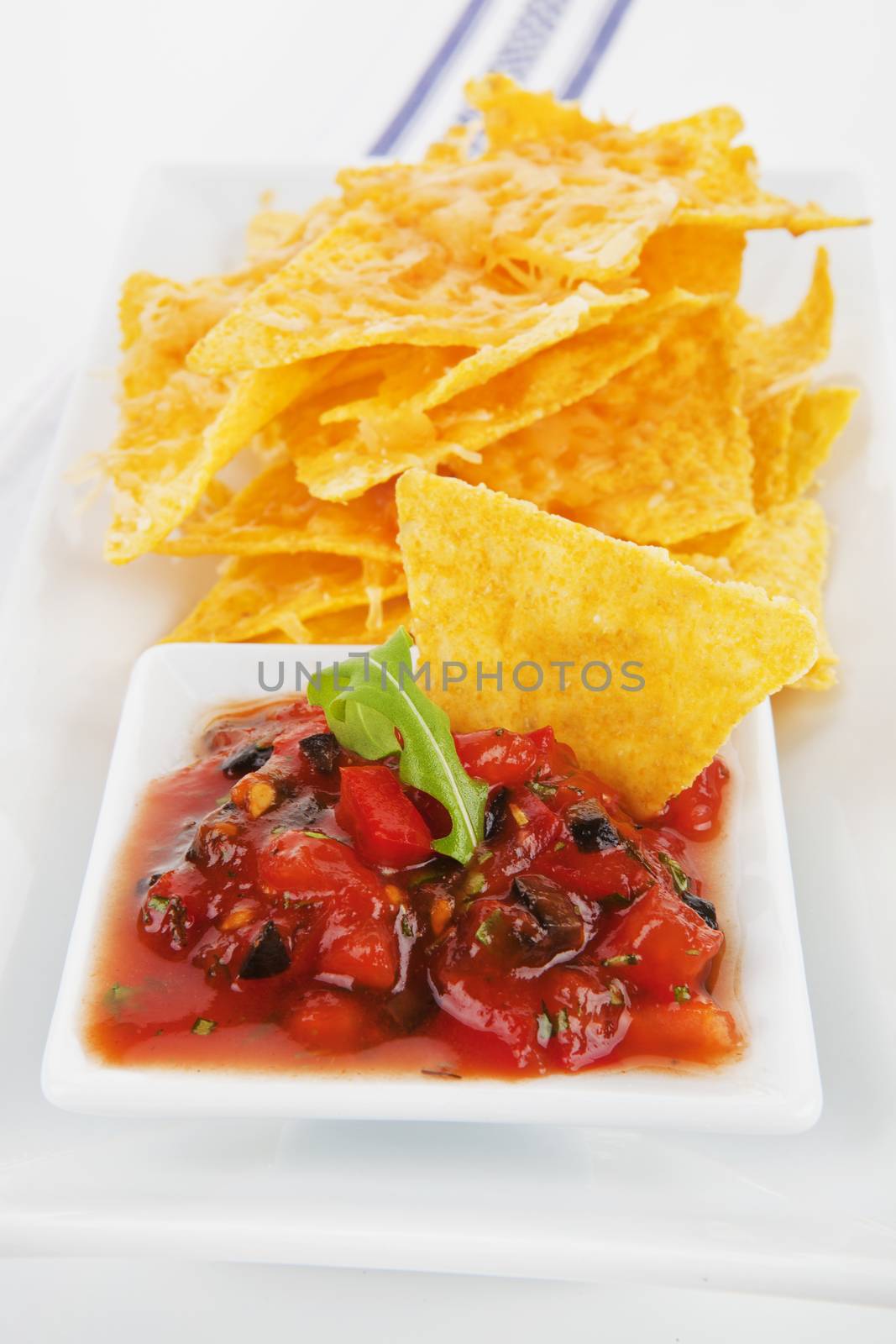 Delicious nachos baked with cheese and tasty homemade tomato sauce.