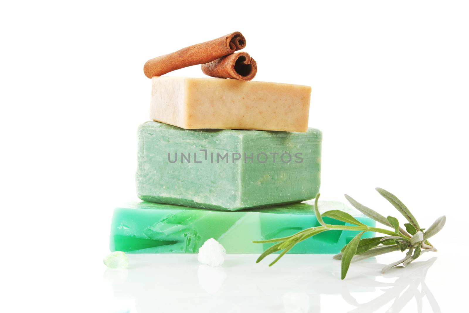 Various soaps arranged. Olive soap and cinnamon soap isolated on white background.
