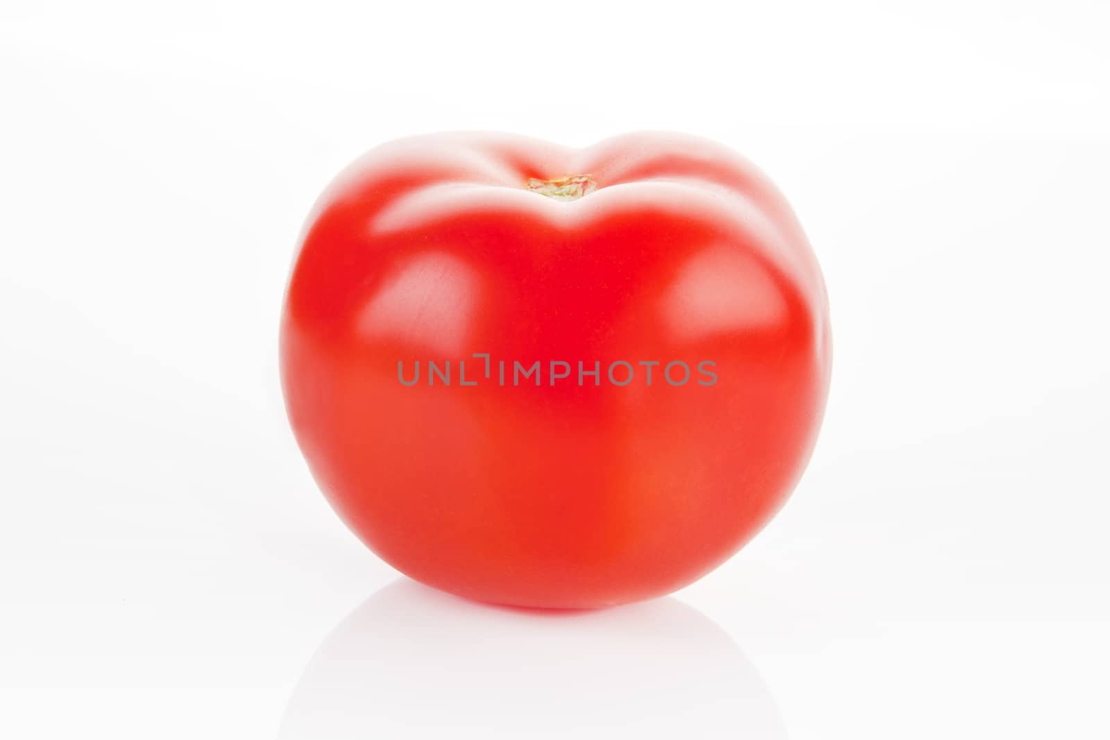 Ripe fresh tomato isolated over white.