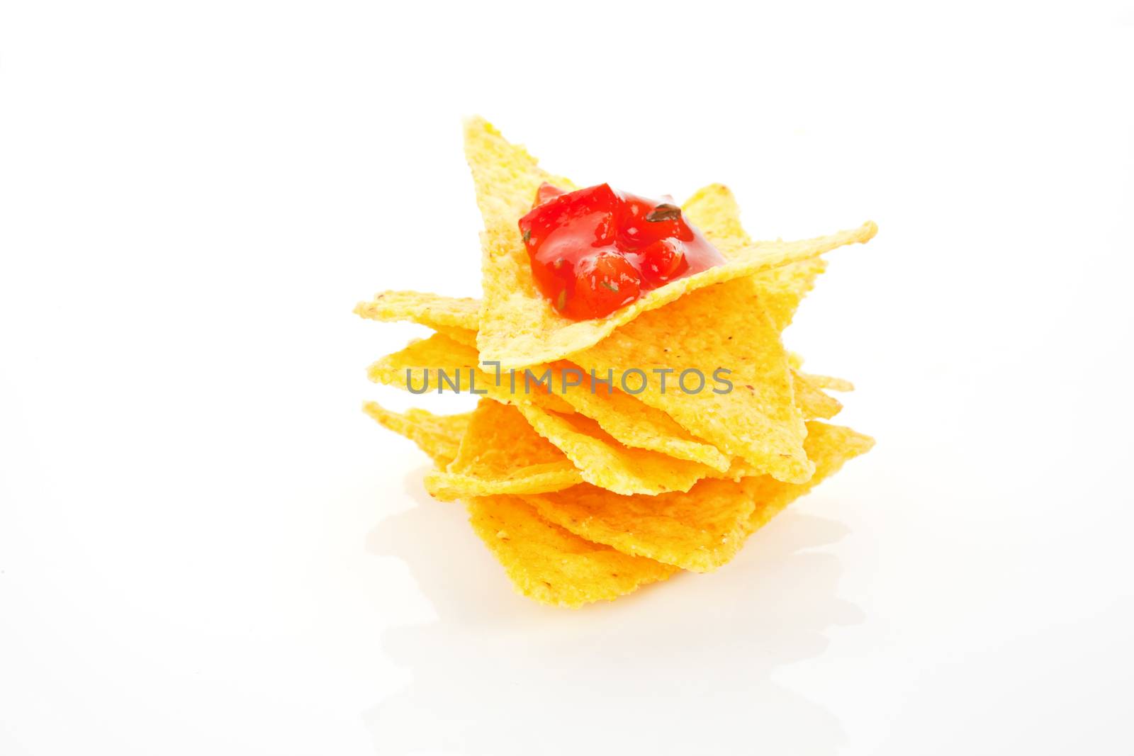 Nachos with tomato dip isolated on white background. Mexican traditional eating.