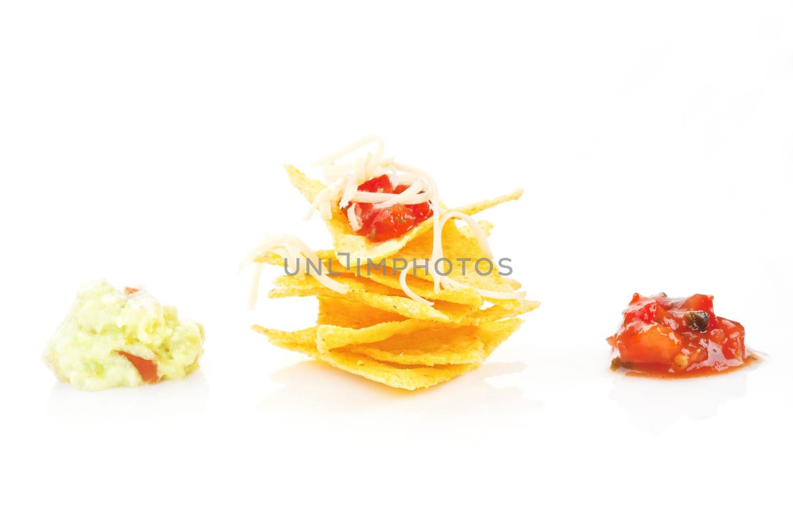 Nachos with cheese and tomato and guacamole dip isolated on white. Mexican eating.