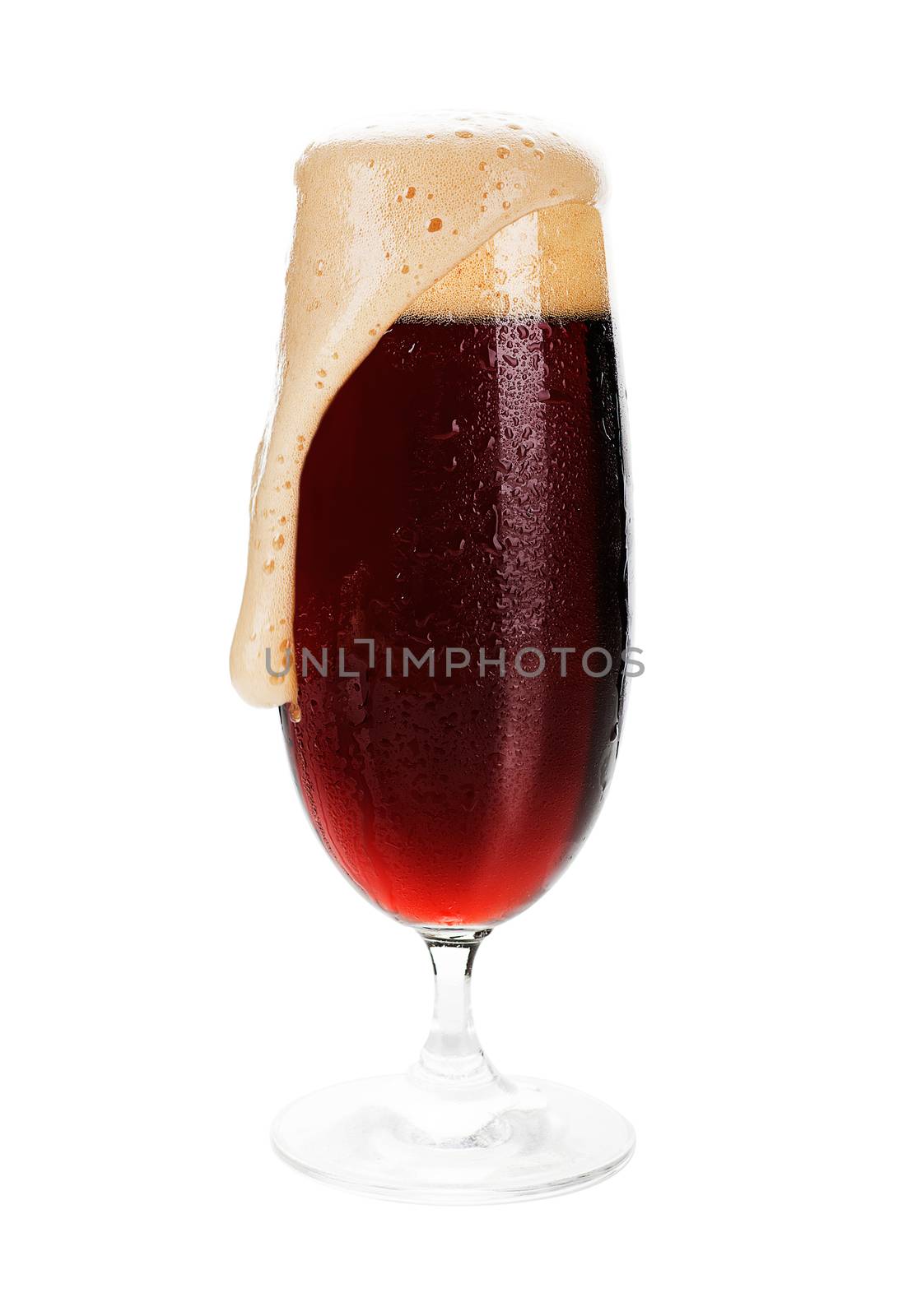 Dark beer. Full cold wet beer glass of dark beer with foam isolated on white.