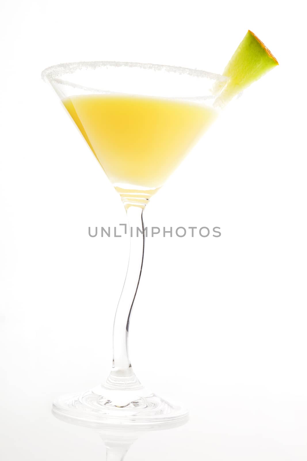 Luxurious yellow cocktail with melon garnish isolated on white background.