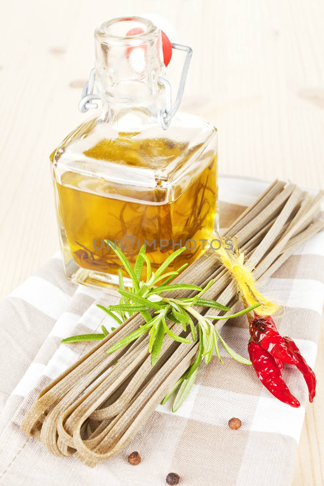 Traditional italian pasta with fresh herbs and olive oil on kitchen towel. 