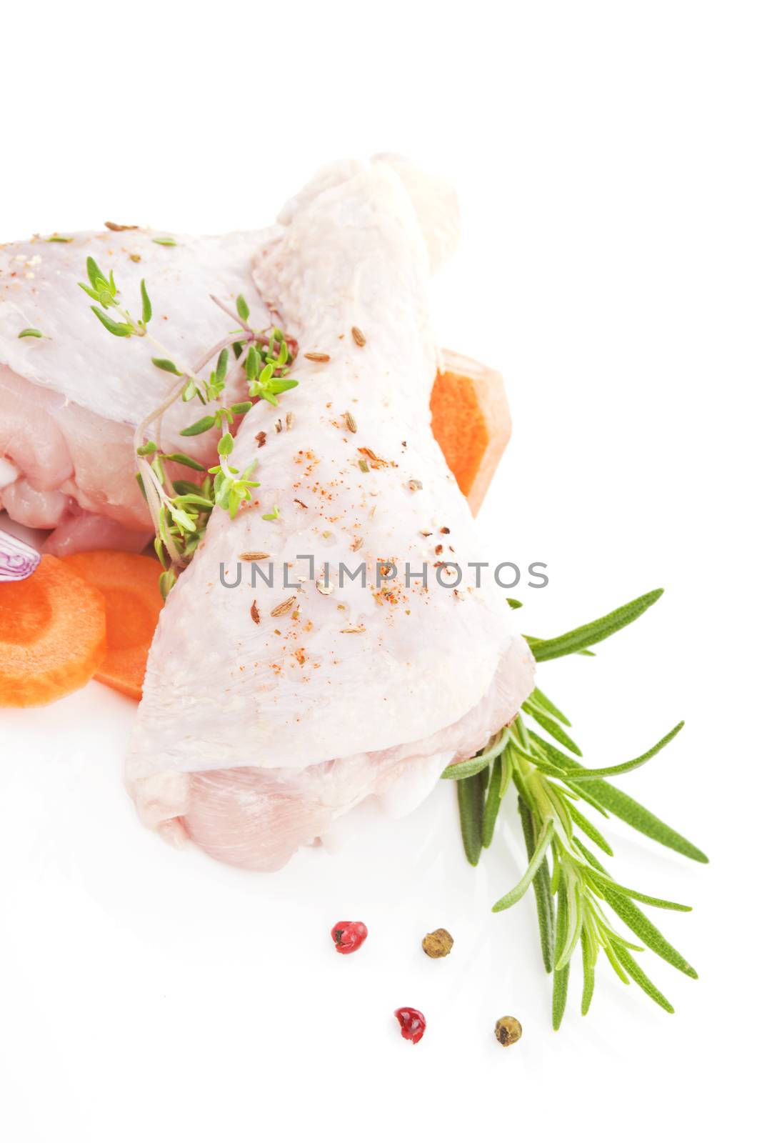 Two chicken legs with fresh vegetables isolated on white background. 
