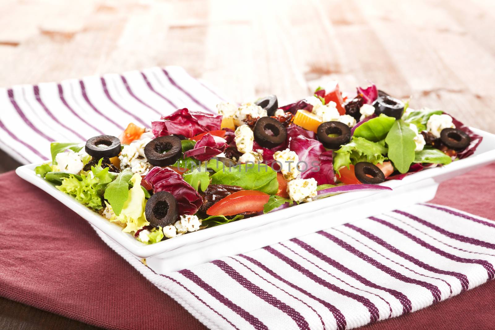 Delicious luxurious colorful fresh summer salad on white plate. 