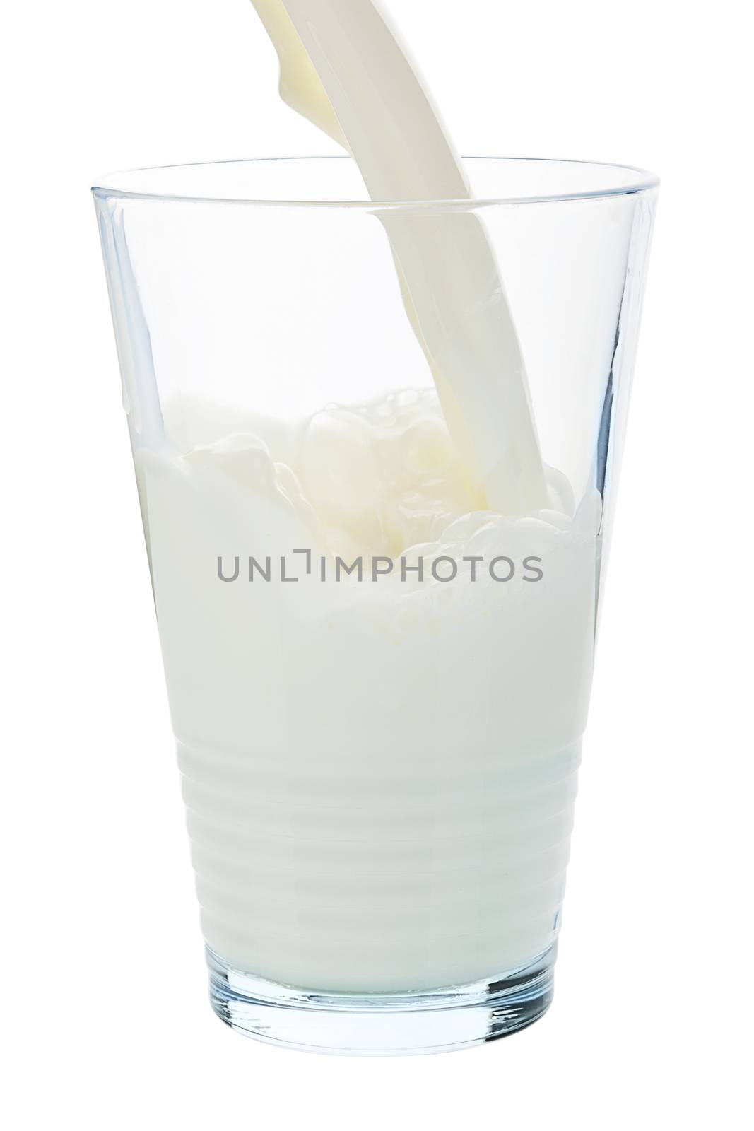 Pouring milk into milk glass isolated on white background with clipping path.