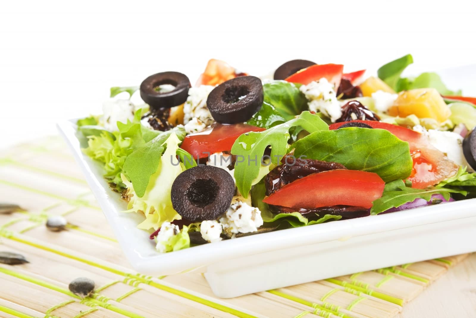 Fresh vegetable salad. Tomato, arugula, olives and cheese salad. 