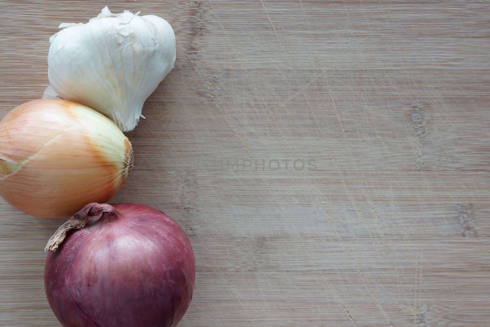A group of vegetables on a wooden cutting board