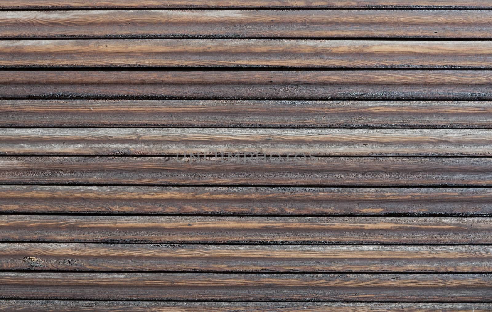 Wood background with horizontal dark brown, tarred planks.