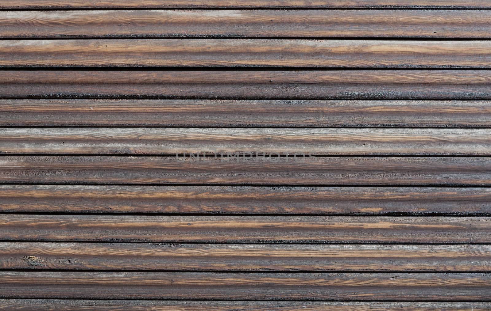 Wood background with horizontal dark brown, tarred planks.