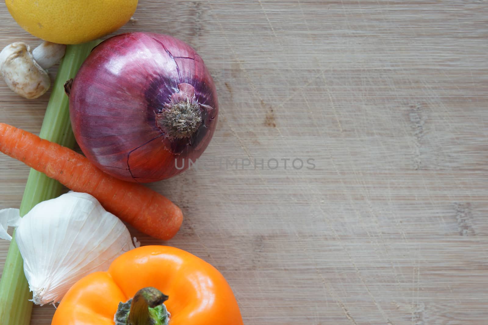 A group of vegetables on a wooden cutting board