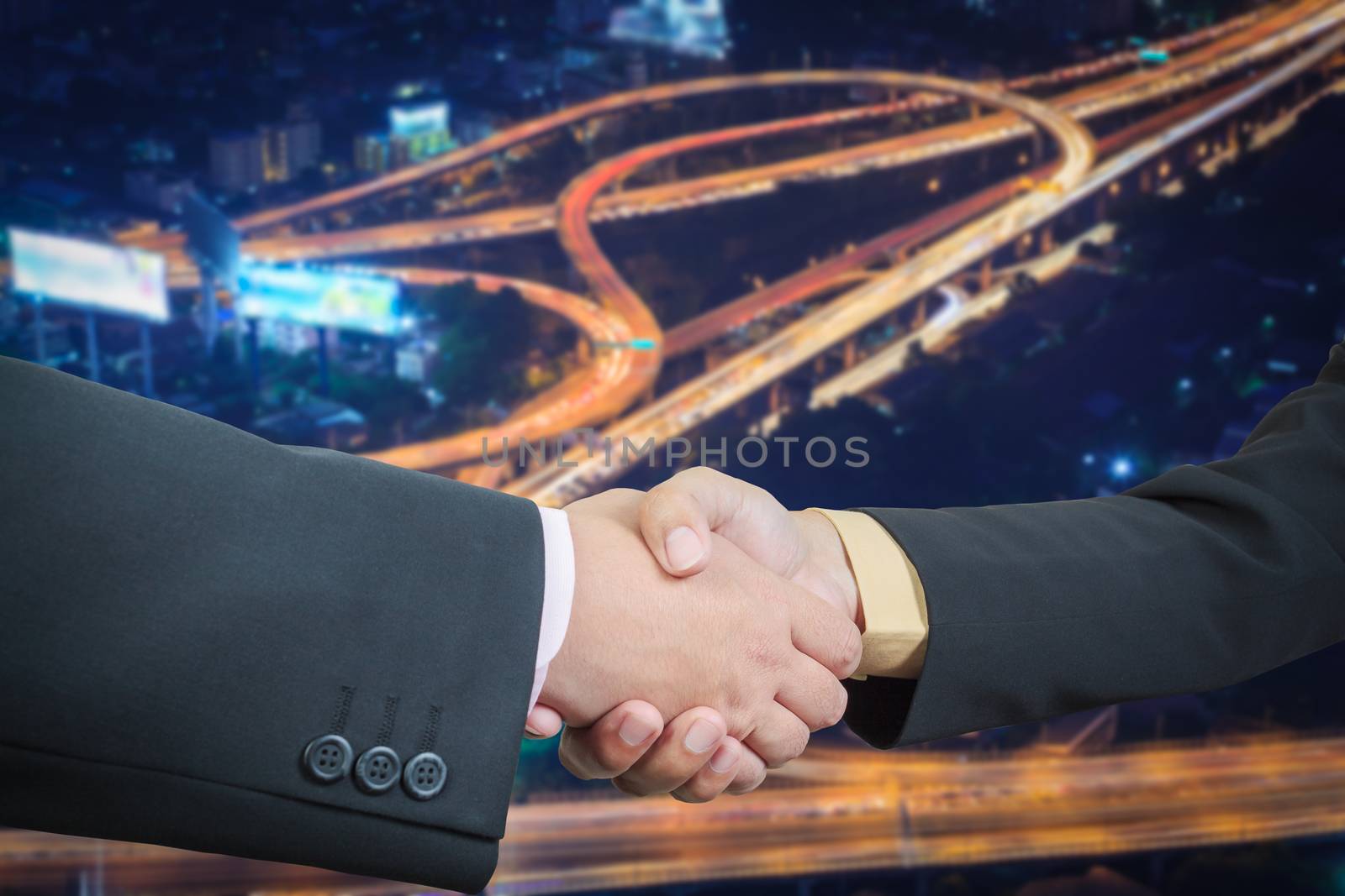 Businessman handshake with power or energy transportation logistic background