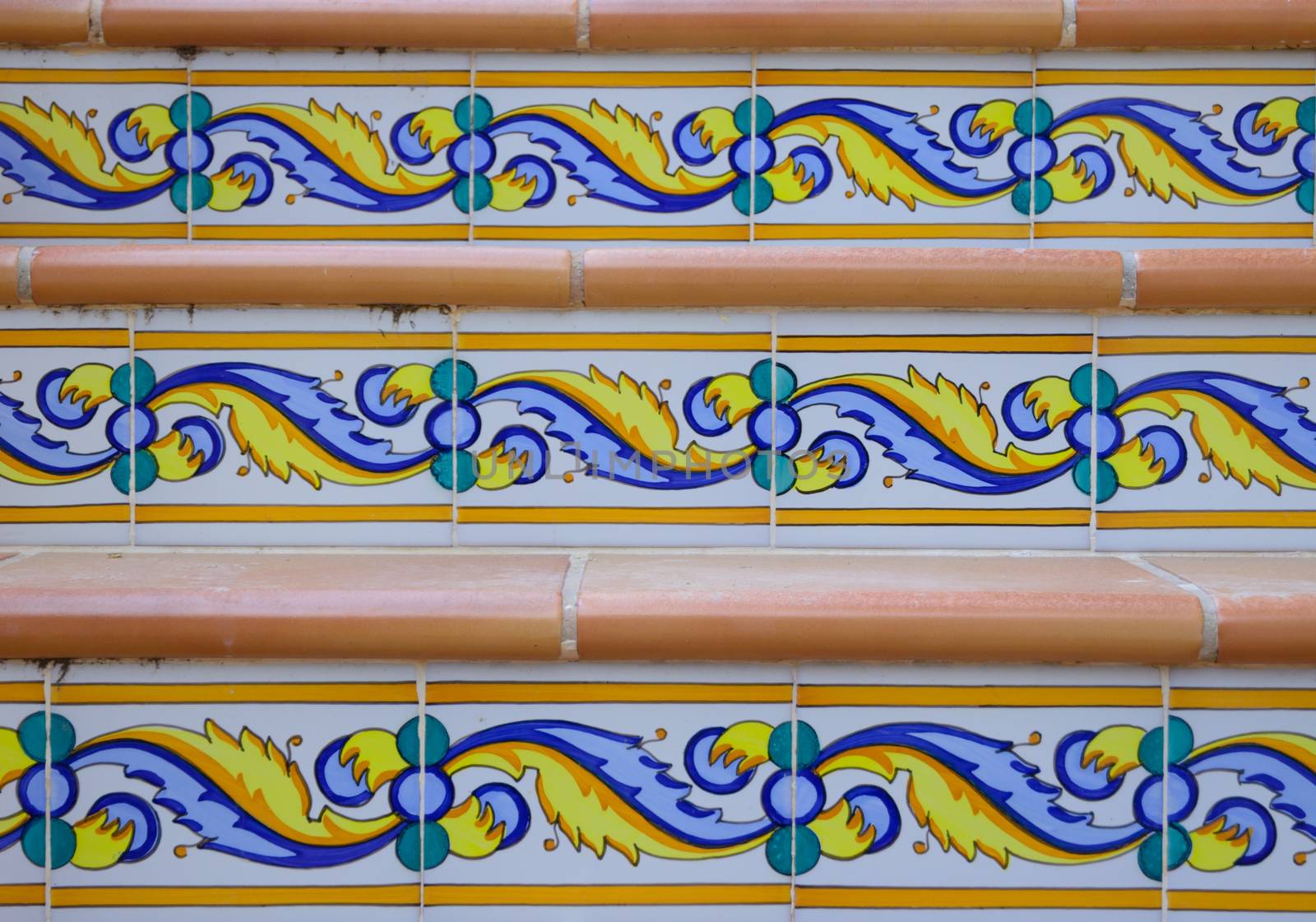 Detail of staircase with patterned ceramic tiles and terracotta.