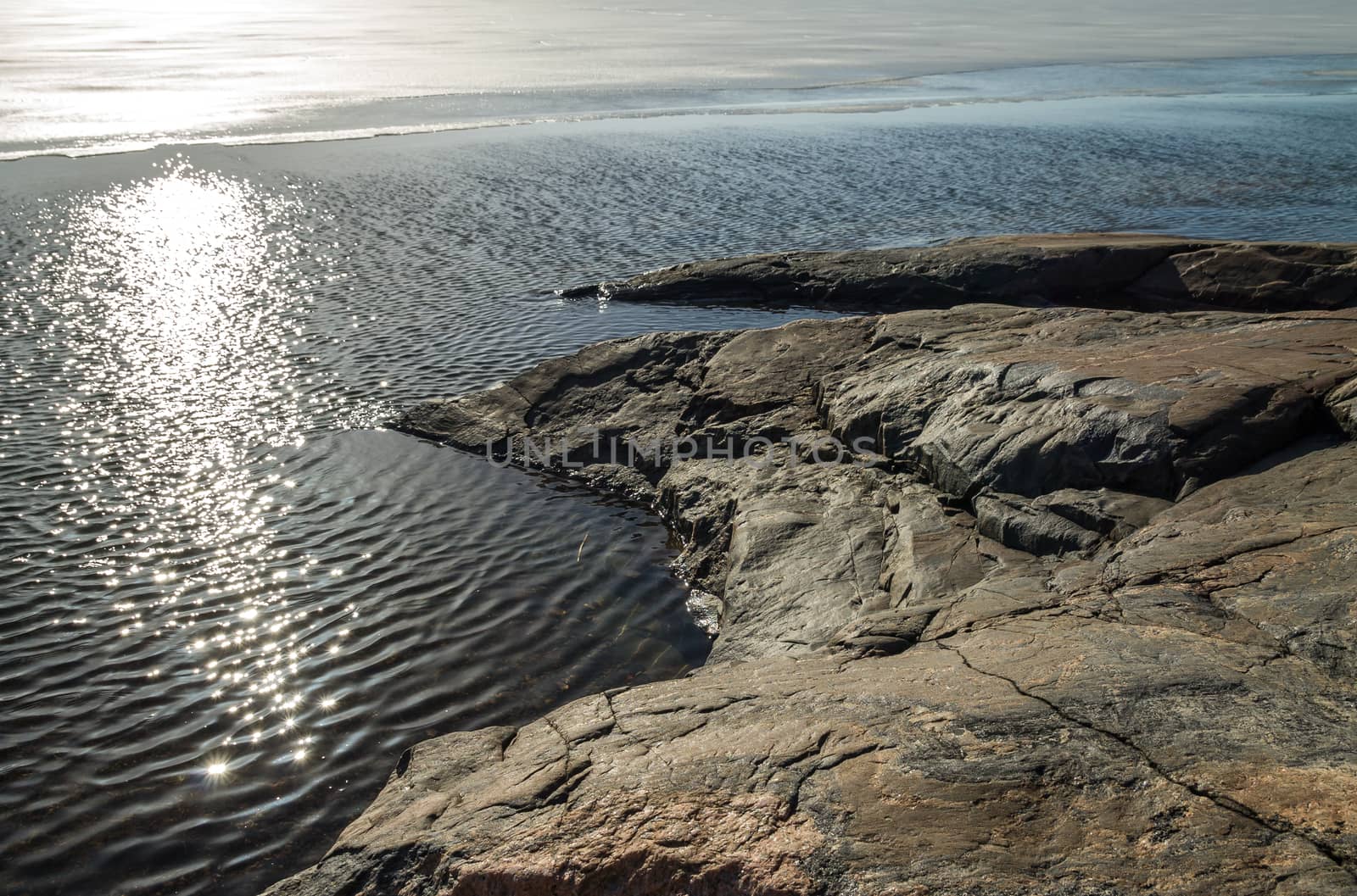 Sunny rocks in the ocean shore by Alexanderphoto
