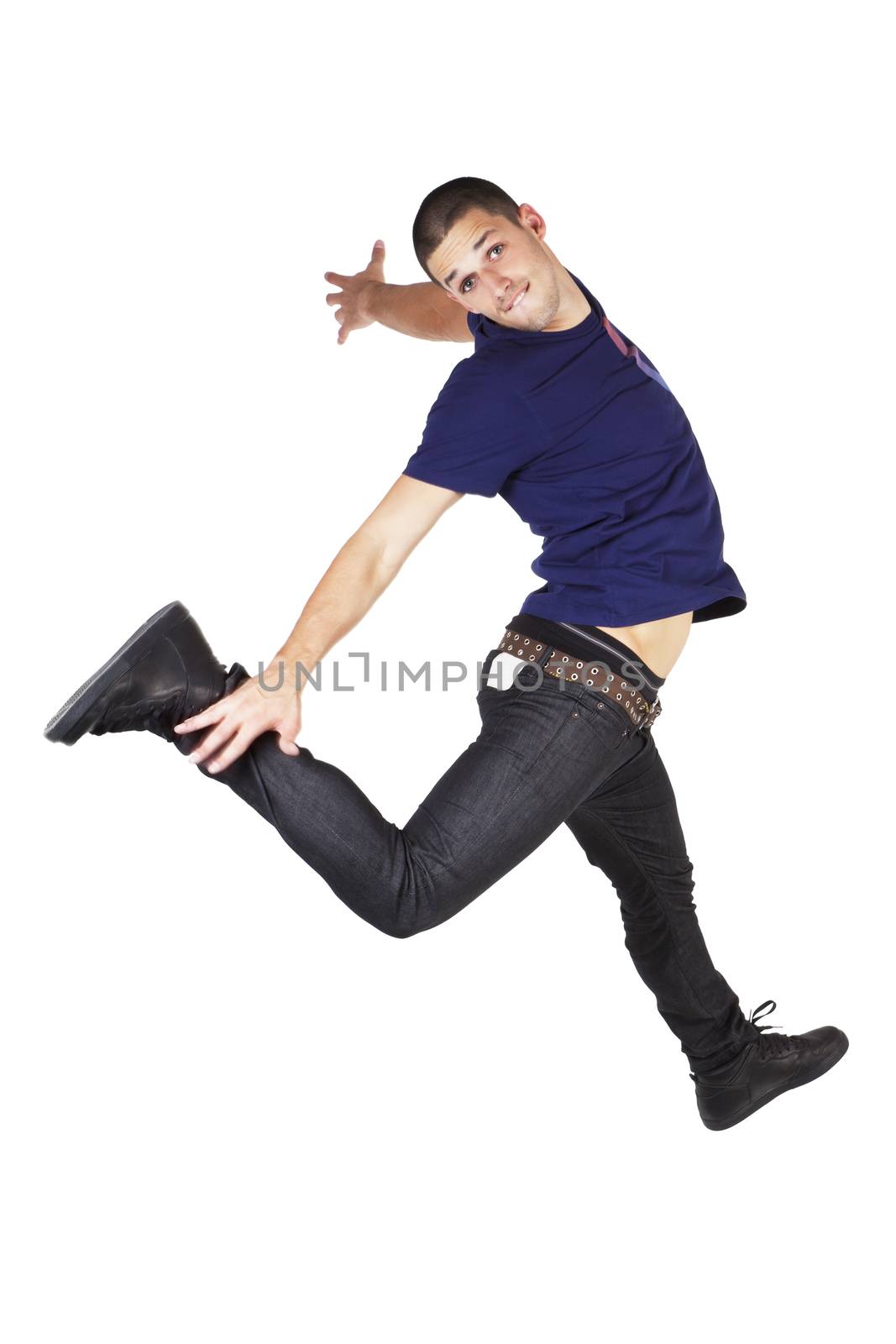 Young man in jeans and t shirt jumping in the air isolated on white background.