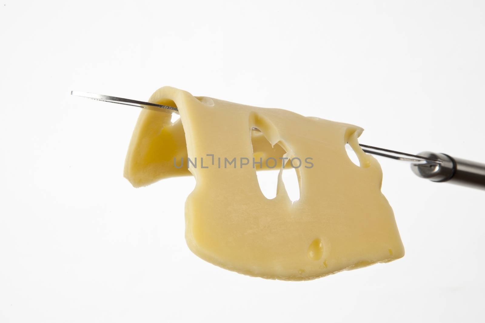 Emmental cheese slice on cheese knife isolated on white background.